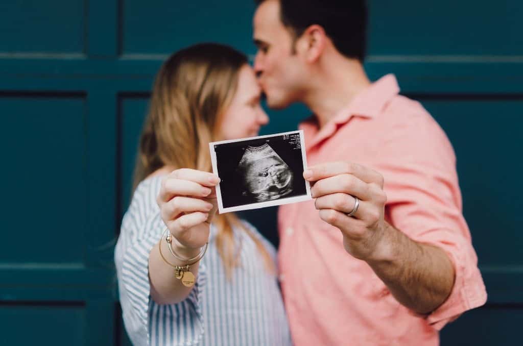 Couple holding baby ultrasound