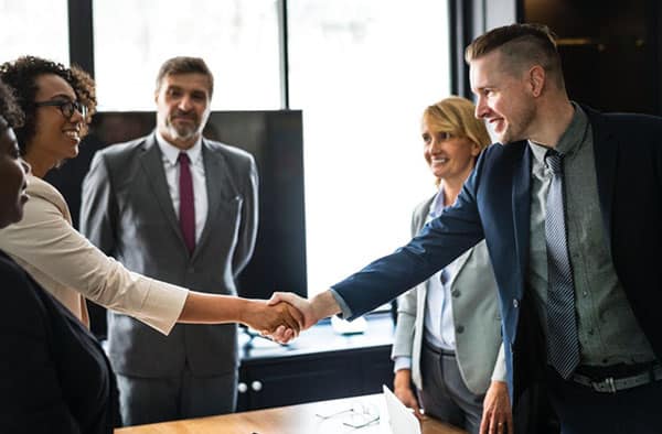 Photo of two people giving a handshake